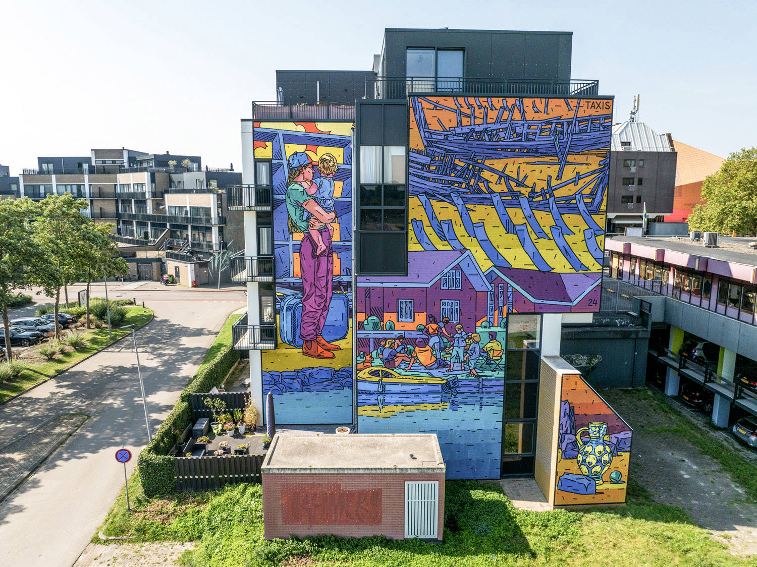 Taxis liet zich inspireren door Batavialand voor deze vier murals, die kleurrijk afsteken tegen het grijze gebouw. We zien o.a. een man die een kind optilt, bij zijn voeten staat een koffer.