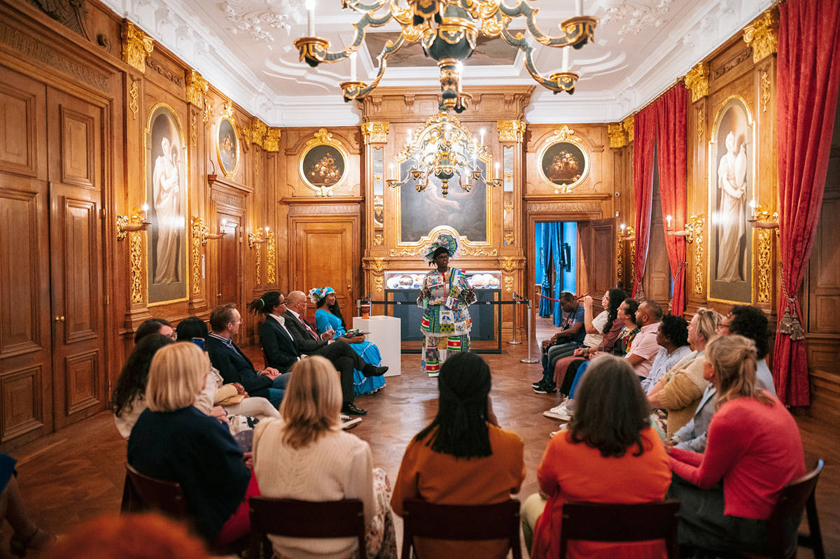 In de Gouden Zaal is een groep mensen ter ere van Keti Koti samengekomen.